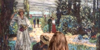 woman looking at Monet garden painting